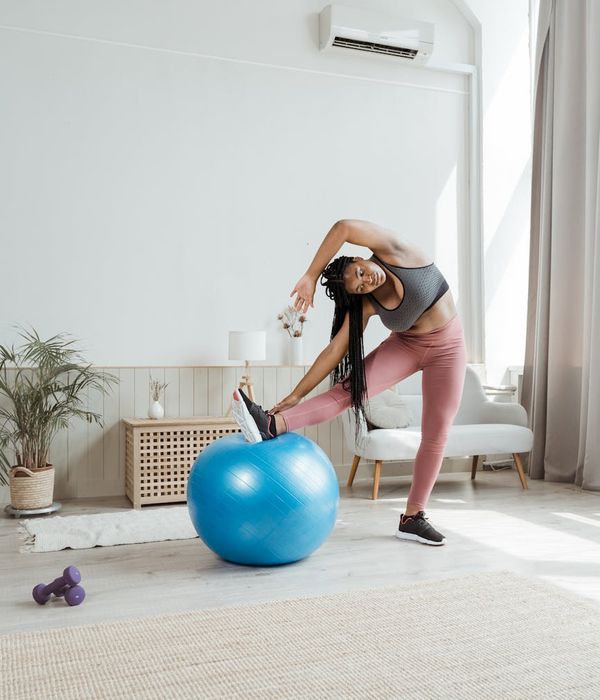 A healthy woman performing dynamic exercises in a bright room